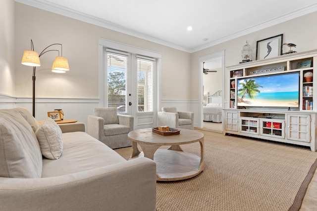 living room featuring crown molding, light carpet, and ceiling fan