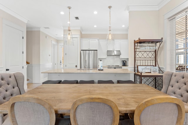 dining area featuring ornamental molding