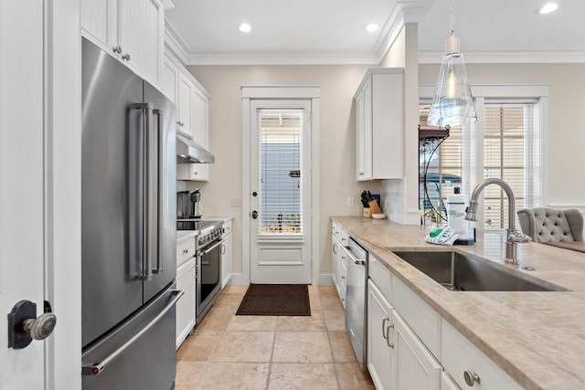 2448 Bungalo Ln, Miramar Beach, FL 32550 - kitchen with premium appliances, a sink, under cabinet range hood, healthy amount of natural light, and crown molding