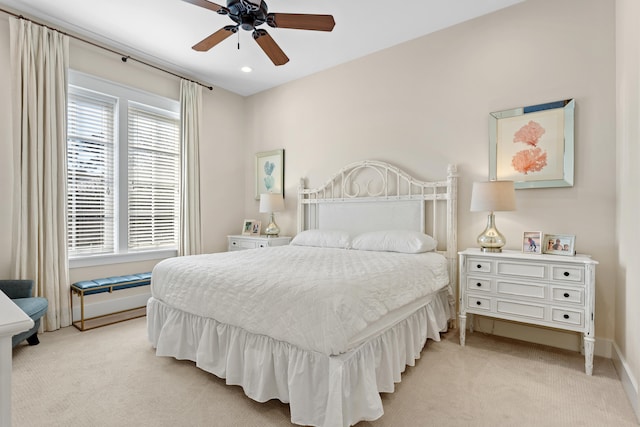 bedroom with light carpet and ceiling fan