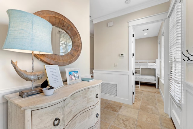 2448 Bungalo Ln, Miramar Beach, FL 32550 - hall with wainscoting, stone tile flooring, and crown molding