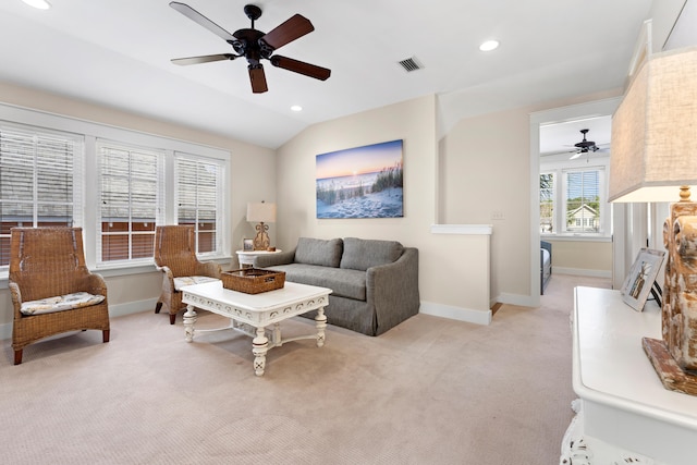 carpeted living room with vaulted ceiling and ceiling fan