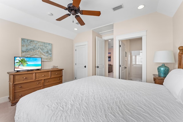 bedroom with ensuite bathroom, vaulted ceiling, carpet floors, and ceiling fan