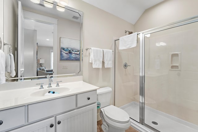 bathroom with vanity, a shower with door, toilet, and vaulted ceiling