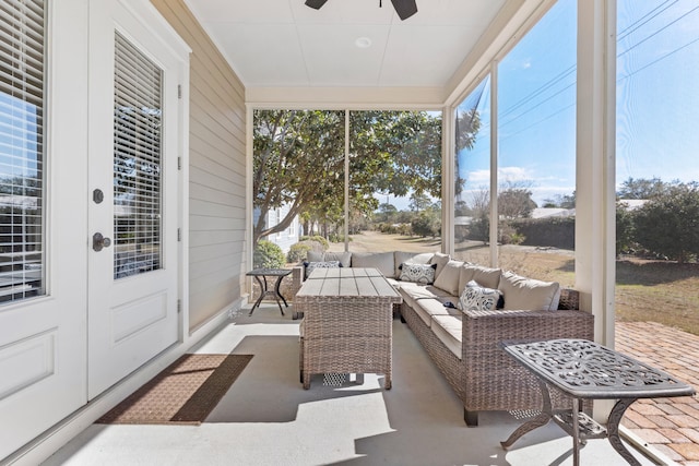 sunroom featuring ceiling fan