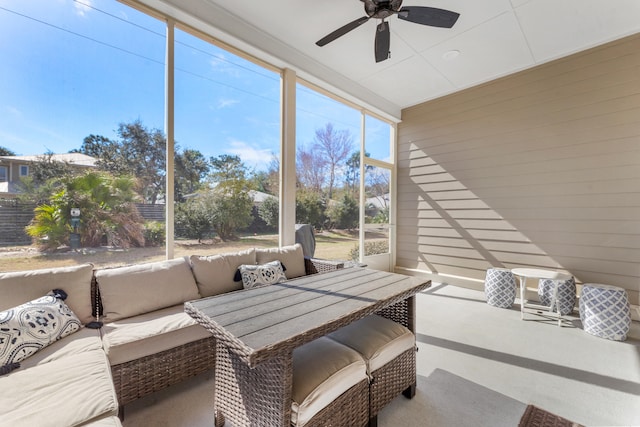 sunroom featuring ceiling fan