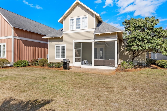 back of house with a yard and a sunroom