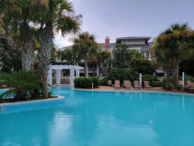 pool at dusk with a pergola