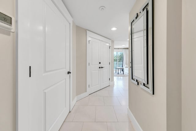 corridor featuring light tile patterned floors