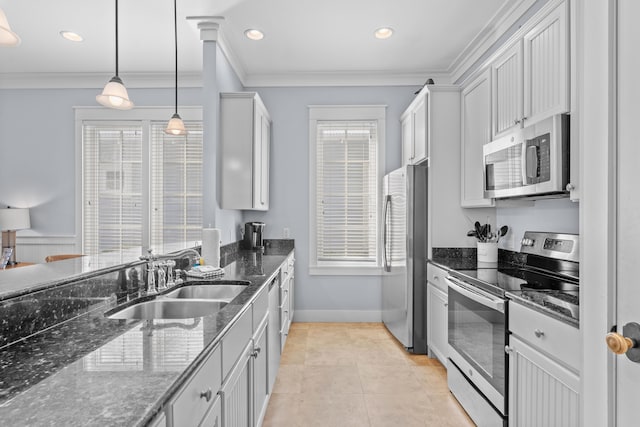 2452 Bungalo Ln, Miramar Beach, FL 32550 - kitchen featuring appliances with stainless steel finishes, a sink, dark stone countertops, decorative light fixtures, and crown molding