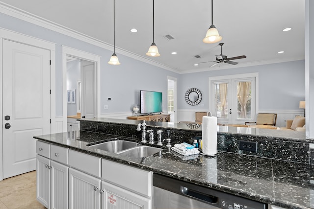 kitchen featuring dishwasher, dark stone counters, sink, decorative light fixtures, and white cabinetry