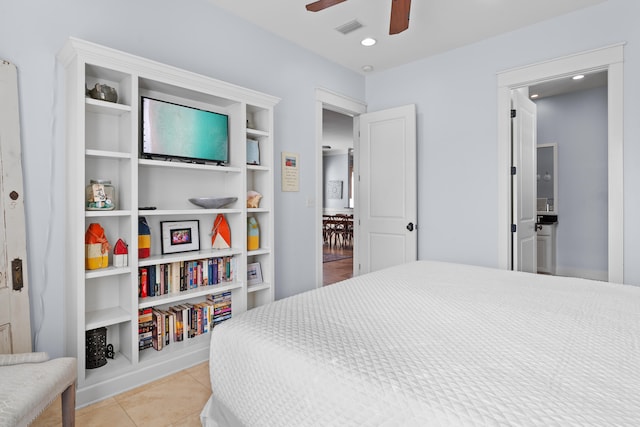 tiled bedroom featuring ceiling fan