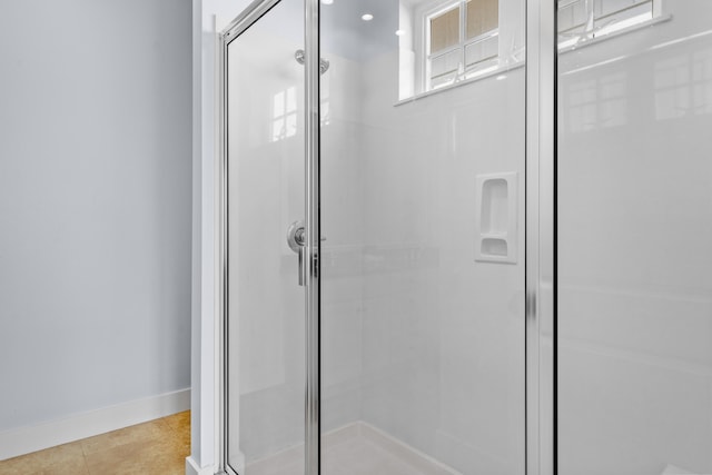 bathroom featuring walk in shower and tile patterned flooring