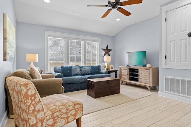 living room with vaulted ceiling, light hardwood / wood-style floors, and ceiling fan