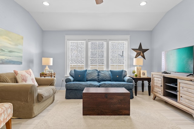 living room with vaulted ceiling, light hardwood / wood-style floors, and ceiling fan