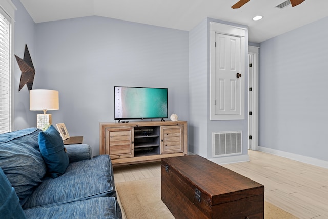 living room with lofted ceiling, wood-type flooring, and ceiling fan