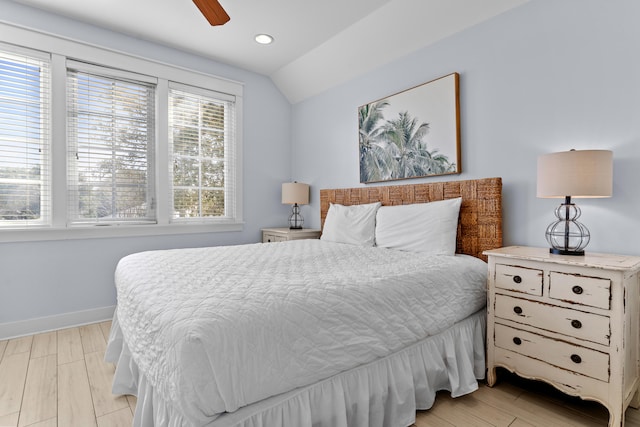 bedroom featuring lofted ceiling, light hardwood / wood-style flooring, and ceiling fan