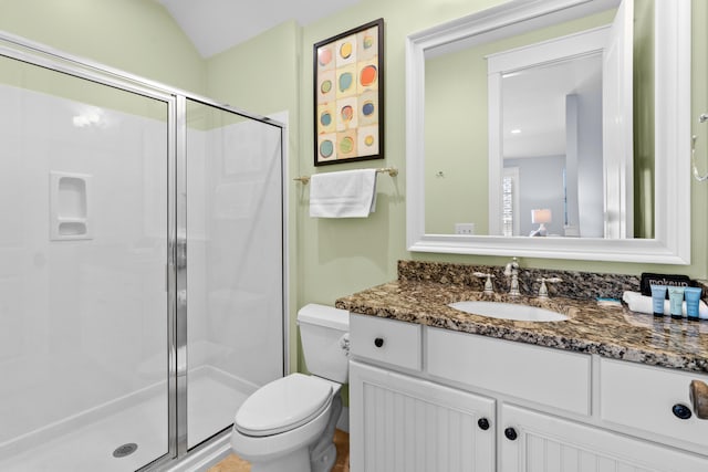 bathroom featuring toilet, an enclosed shower, vanity, and lofted ceiling