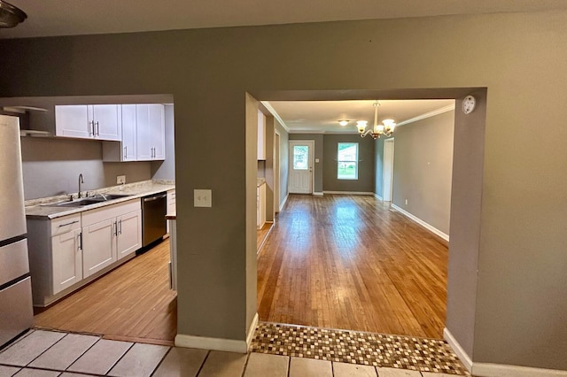 297 Anderson St, Crestview, FL 32536 - kitchen with appliances with stainless steel finishes, a sink, baseboards, a chandelier, and ornamental molding