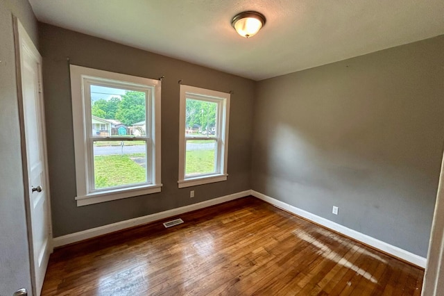 297 Anderson St, Crestview, FL 32536 - empty room with hardwood / wood-style flooring and baseboards