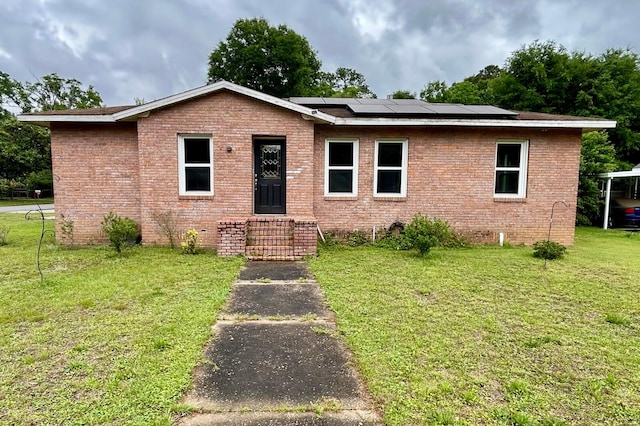 297 Anderson St, Crestview, FL 32536 - single story home with a front yard, solar panels, brick siding, and entry steps