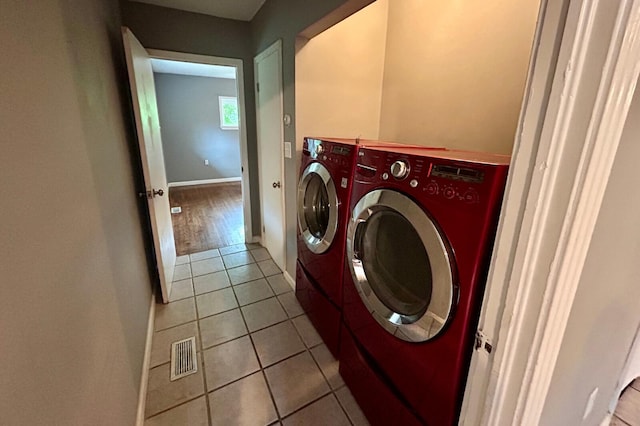 297 Anderson St, Crestview, FL 32536 - laundry area featuring washing machine and dryer, light tile patterned flooring, and baseboards