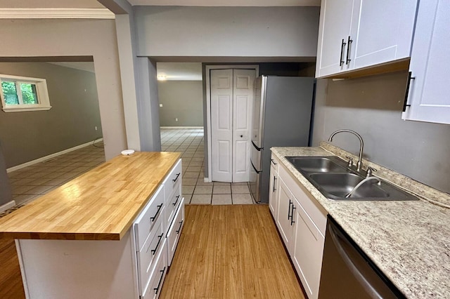 297 Anderson St, Crestview, FL 32536 - kitchen featuring wooden counters, appliances with stainless steel finishes, a sink, white cabinets, and light tile patterned floors