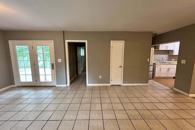 297 Anderson St, Crestview, FL 32536 - unfurnished living room with light tile patterned flooring, baseboards, and a sink