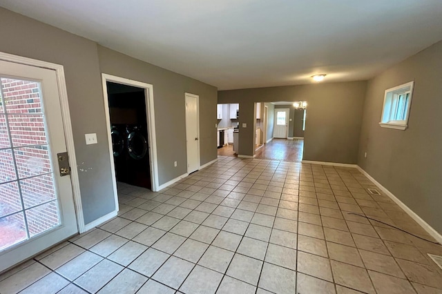 297 Anderson St, Crestview, FL 32536 - spare room featuring washer and clothes dryer, baseboards, and light tile patterned floors
