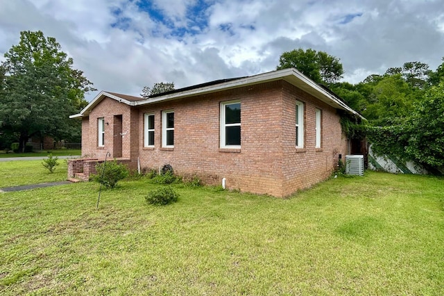 297 Anderson St, Crestview, FL 32536 - view of side of home with a lawn, central air condition unit, and brick siding