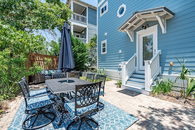 view of patio featuring an outdoor hangout area and a balcony