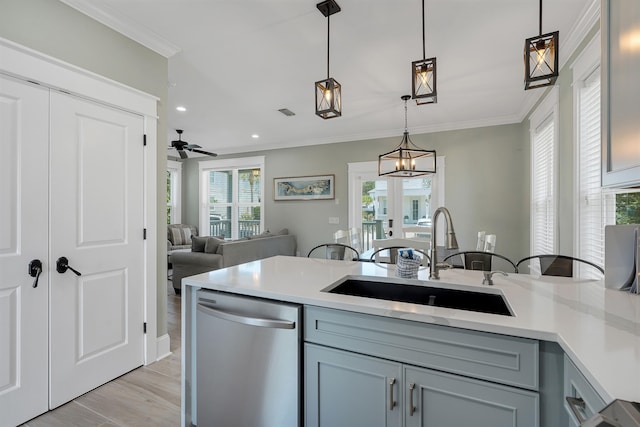 kitchen with light wood-type flooring, crown molding, sink, and stainless steel dishwasher