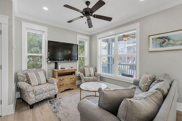 living room featuring light hardwood / wood-style floors, a healthy amount of sunlight, and ornamental molding