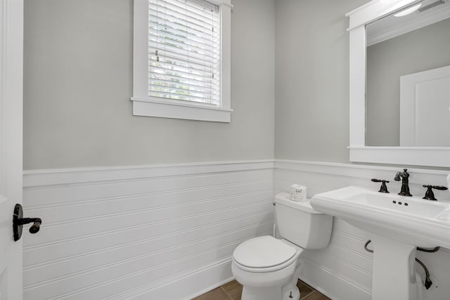 bathroom featuring toilet and tile patterned floors