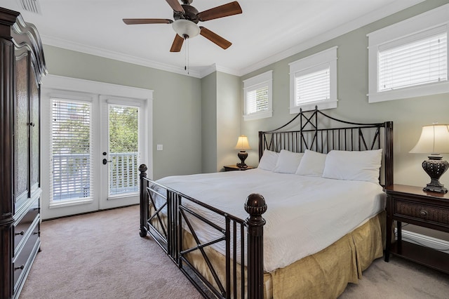 carpeted bedroom featuring ceiling fan, access to outside, multiple windows, and ornamental molding