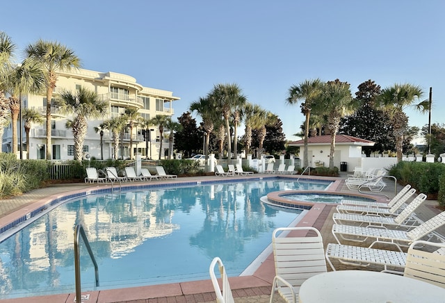 view of pool with a patio area and a community hot tub