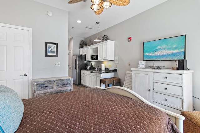 bedroom with stainless steel fridge and sink