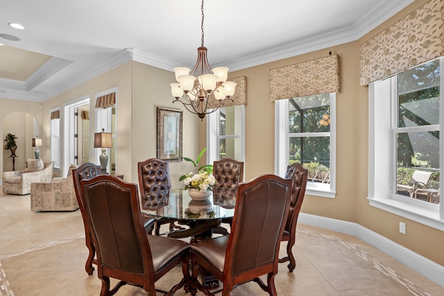 tiled dining room featuring crown molding and a chandelier