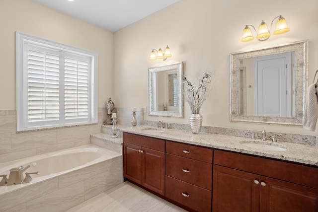 bathroom with vanity and a relaxing tiled tub