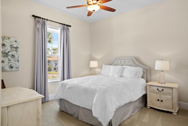 bedroom with light carpet and ceiling fan