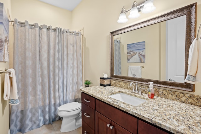 bathroom featuring vanity, toilet, and tile patterned flooring