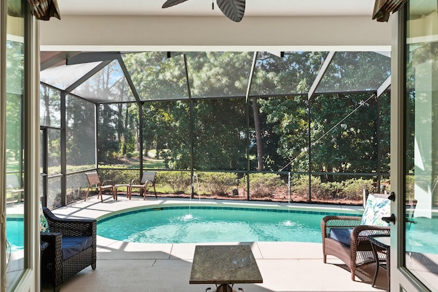 view of swimming pool with a patio and glass enclosure