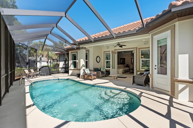 view of pool featuring a patio, ceiling fan, a lanai, and outdoor lounge area