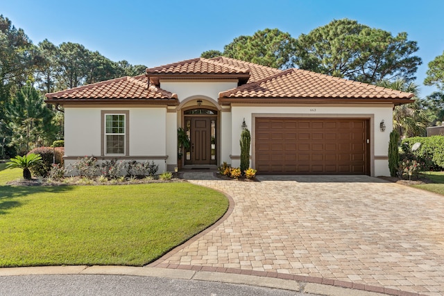 mediterranean / spanish-style home with a front yard and a garage