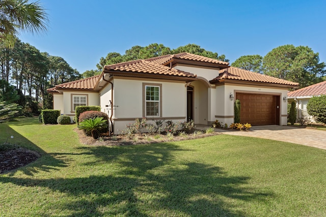 mediterranean / spanish-style home with a garage and a front lawn