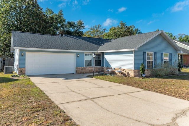 single story home featuring a garage, central air condition unit, and a front lawn