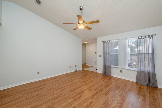 9 Holly Rd, Crestview, FL 32539 - spare room featuring light wood finished floors, a ceiling fan, visible vents, baseboards, and vaulted ceiling