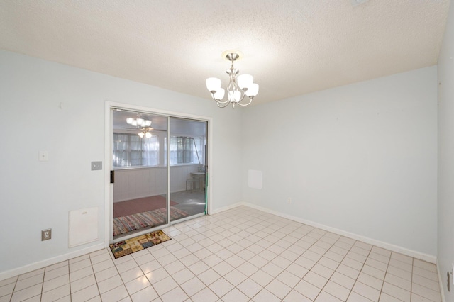 9 Holly Rd, Crestview, FL 32539 - empty room featuring baseboards, an inviting chandelier, light tile patterned floors, and a textured ceiling