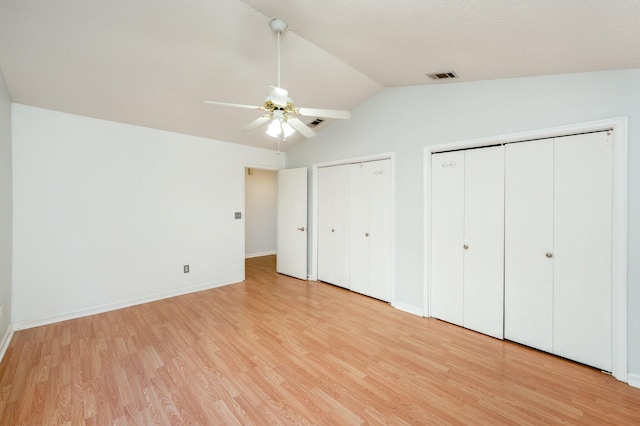 9 Holly Rd, Crestview, FL 32539 - unfurnished bedroom featuring lofted ceiling, light wood-type flooring, multiple closets, visible vents, and baseboards