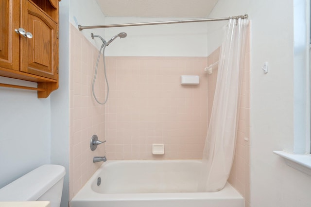 bathroom featuring shower / bath combo and toilet